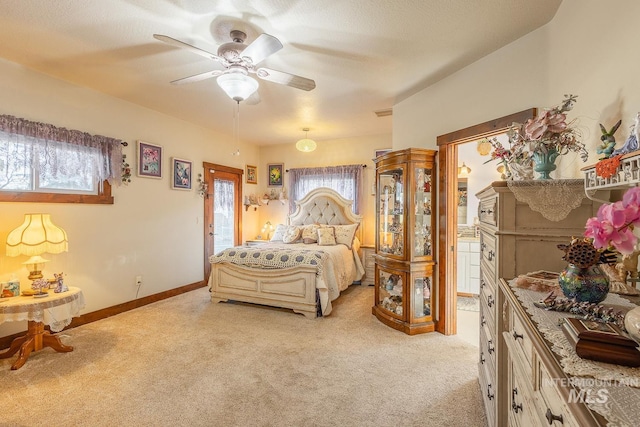 bedroom featuring ceiling fan, light carpet, multiple windows, and access to outside