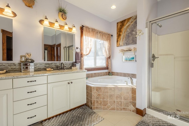 bathroom with tile patterned floors, independent shower and bath, and vanity