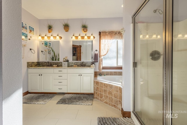 bathroom featuring vanity, tile patterned flooring, and separate shower and tub