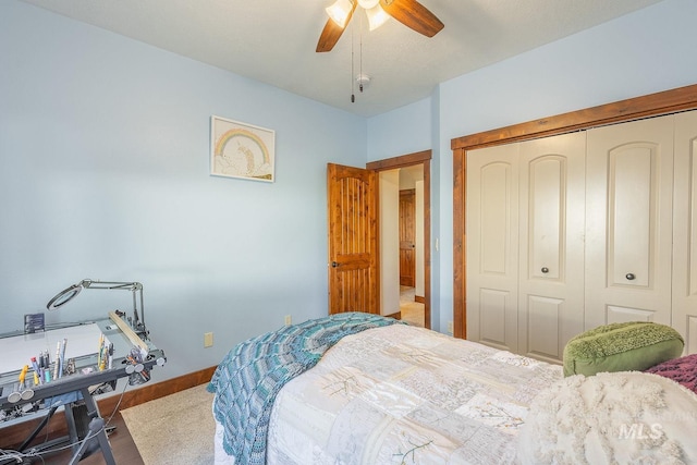 bedroom with ceiling fan, wood-type flooring, and a closet