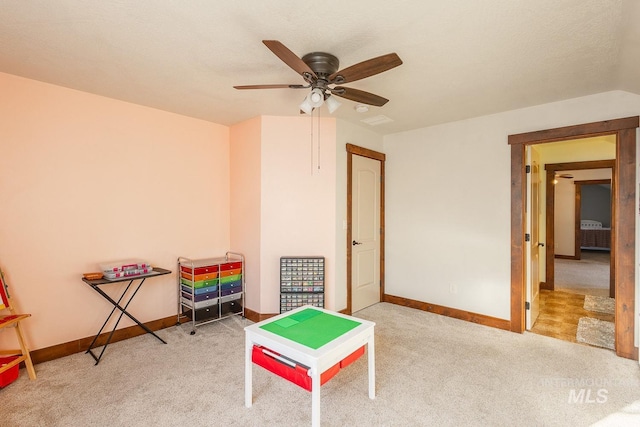 playroom featuring ceiling fan, carpet floors, and a textured ceiling