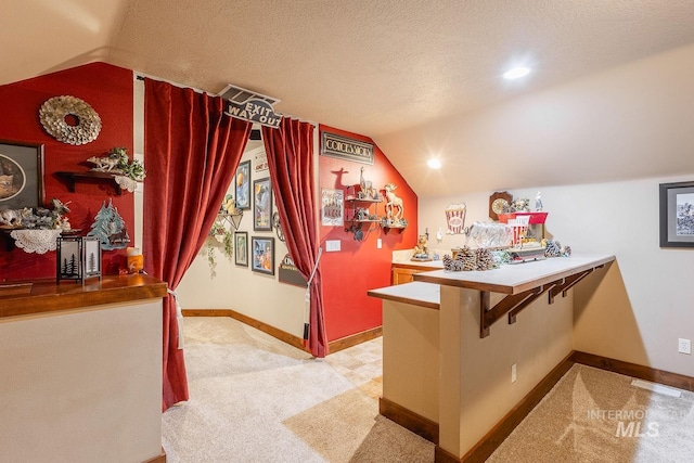 interior space with lofted ceiling and a textured ceiling