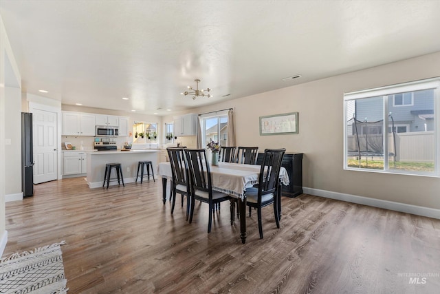 12817 Ironstone Dr, Nampa, ID 83651 - dining space with a chandelier, light wood-type flooring, baseboards, and recessed lighting