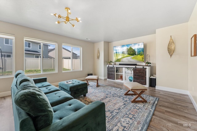 12817 Ironstone Dr, Nampa, ID 83651 - living room featuring baseboards, a chandelier, and wood finished floors