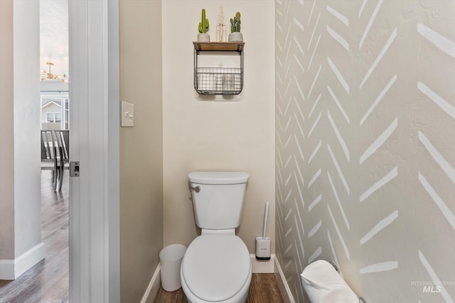 12817 Ironstone Dr, Nampa, ID 83651 - bathroom with wood finished floors, baseboards, toilet, and a chandelier