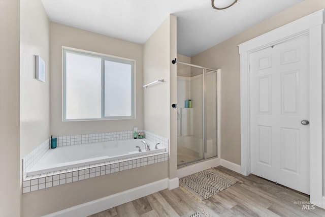 12817 Ironstone Dr, Nampa, ID 83651 - full bath featuring a bath, a shower stall, wood finished floors, and baseboards