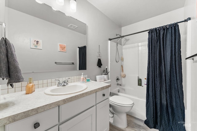 12817 Ironstone Dr, Nampa, ID 83651 - bathroom featuring vanity, toilet, shower / tub combo, wood finished floors, and tasteful backsplash
