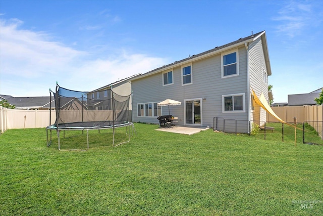 12817 Ironstone Dr, Nampa, ID 83651 - back of house featuring a trampoline and a patio area