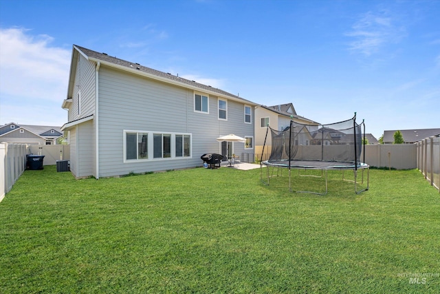 12817 Ironstone Dr, Nampa, ID 83651 - back of house featuring a trampoline, cooling unit, and a patio