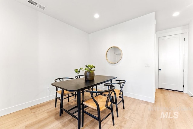 dining area featuring baseboards, light wood-type flooring, and recessed lighting
