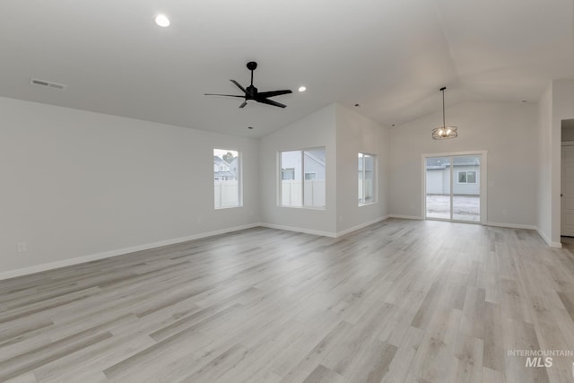 unfurnished living room featuring a ceiling fan, visible vents, light wood-style flooring, baseboards, and lofted ceiling
