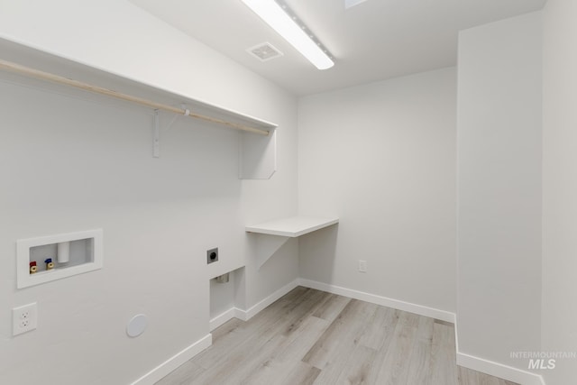 laundry room with laundry area, electric dryer hookup, light wood-style floors, washer hookup, and visible vents