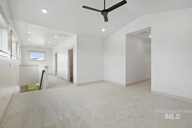 carpeted empty room featuring ceiling fan and lofted ceiling