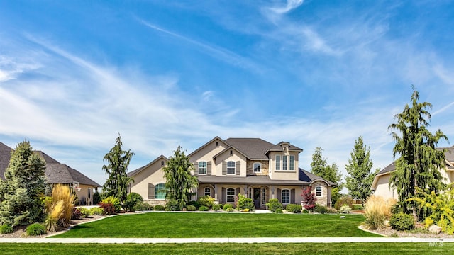 7127 S Pear Blossom Way, Meridian, ID 83642 - view of front of home featuring stone siding, a front yard, and stucco siding