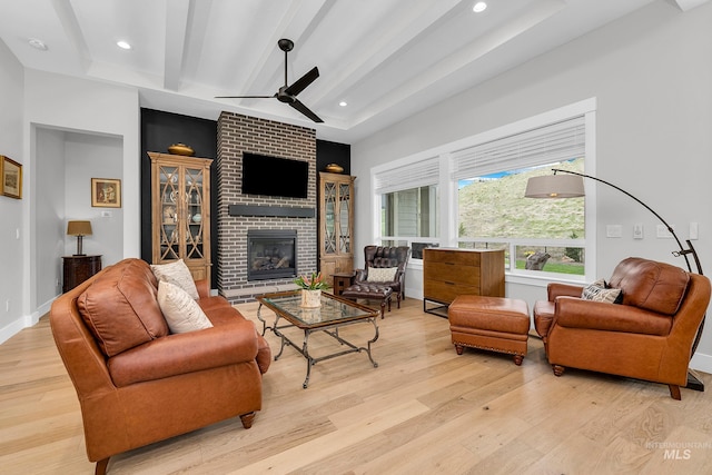 living room featuring light wood finished floors, recessed lighting, ceiling fan, and a fireplace