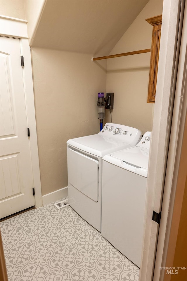 6023 S Augustine Ave, Boise, ID 83709 - laundry room featuring washer and clothes dryer, cabinet space, light tile patterned floors, and baseboards