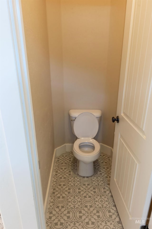 6023 S Augustine Ave, Boise, ID 83709 - bathroom featuring toilet, baseboards, and tile patterned flooring