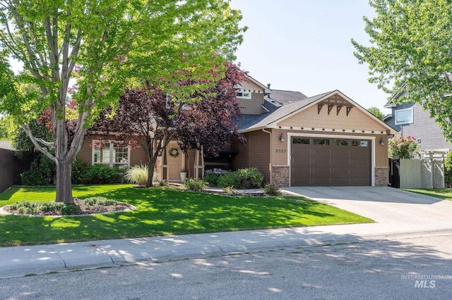 6023 S Augustine Ave, Boise, ID 83709 - view of front of house featuring a garage, concrete driveway, and stone siding