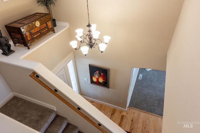 6023 S Augustine Ave, Boise, ID 83709 - staircase with a chandelier, wood finished floors, and baseboards
