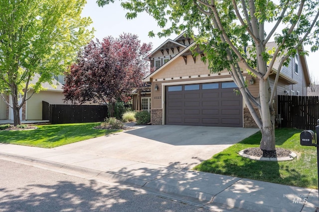 6023 S Augustine Ave, Boise, ID 83709 - view of front facade with stone siding, an attached garage, and concrete driveway