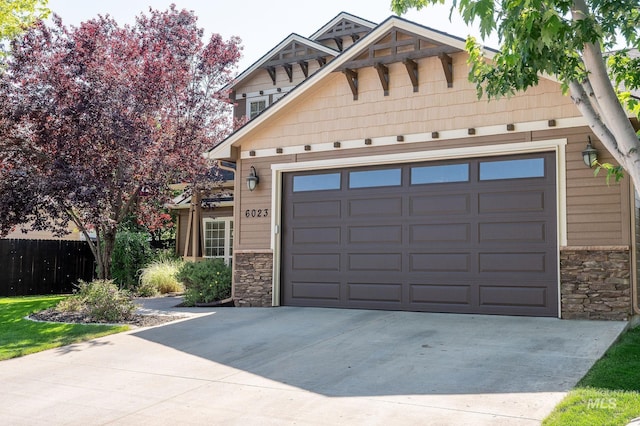 6023 S Augustine Ave, Boise, ID 83709 - view of front of property featuring stone siding, concrete driveway, and an attached garage