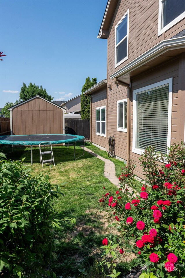 6023 S Augustine Ave, Boise, ID 83709 - view of yard featuring a trampoline and an outdoor structure