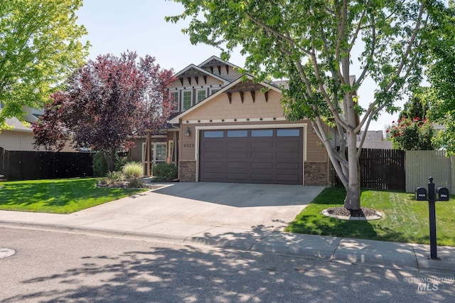 6023 S Augustine Ave, Boise, ID 83709 - view of front of house featuring concrete driveway, stone siding, and a garage