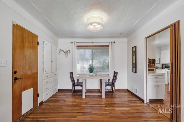 833 Nebraska, Gooding, ID 83330 - dining room featuring a textured ceiling and wood finished floors