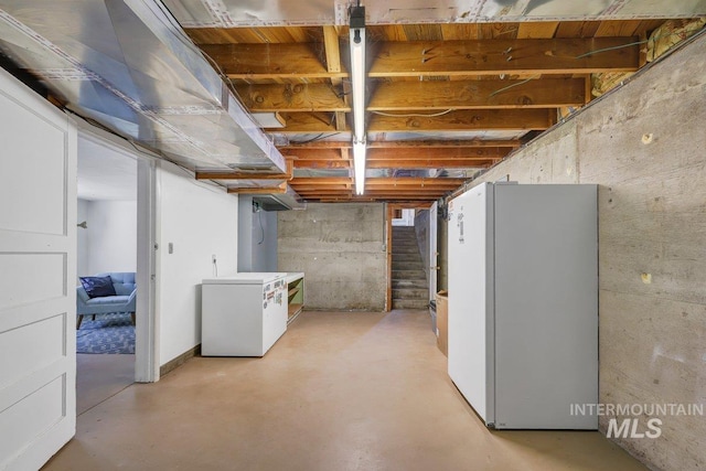 833 Nebraska, Gooding, ID 83330 - unfinished basement featuring freestanding refrigerator, refrigerator, and stairway
