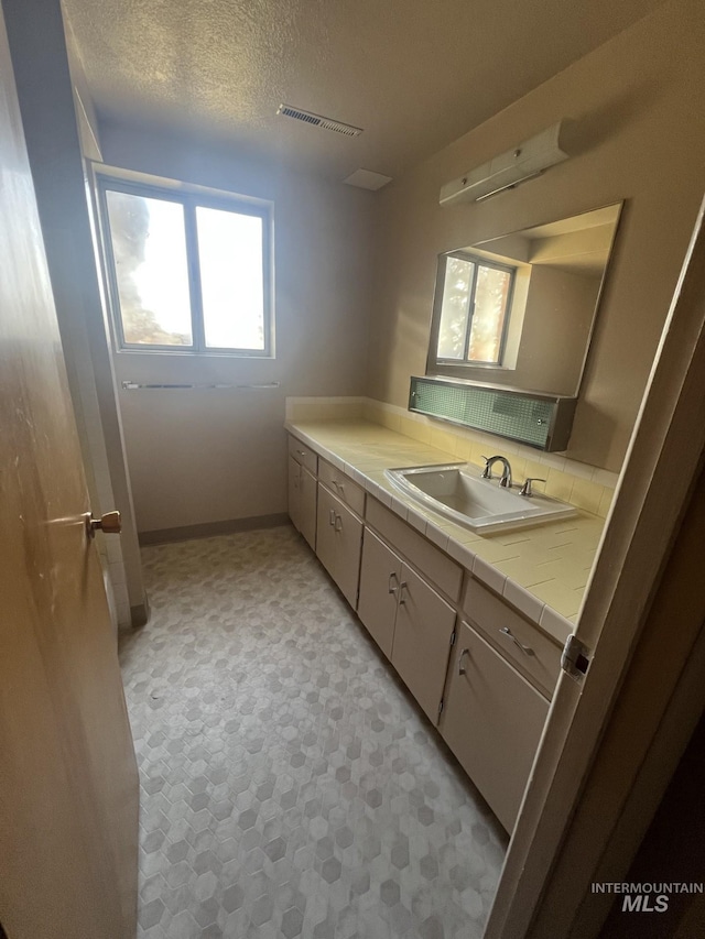 bathroom featuring vanity and a textured ceiling