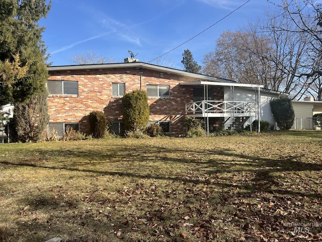 rear view of house with a yard