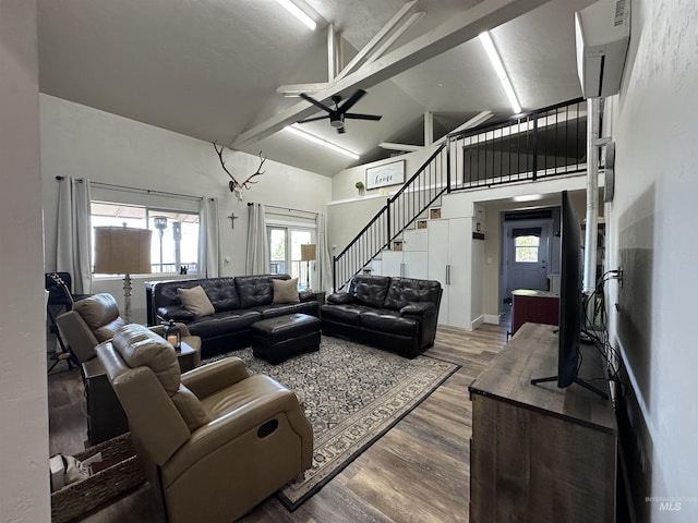 living room featuring high vaulted ceiling, a ceiling fan, stairs, and wood finished floors