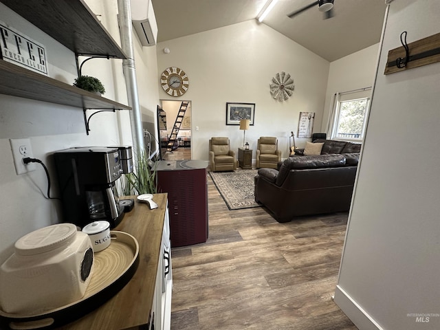 interior space featuring high vaulted ceiling, a wall mounted air conditioner, and wood finished floors