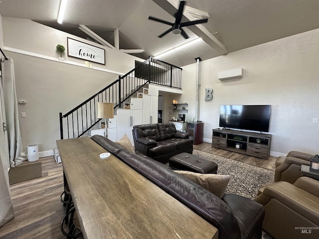 living area featuring stairs, high vaulted ceiling, ceiling fan, and wood finished floors