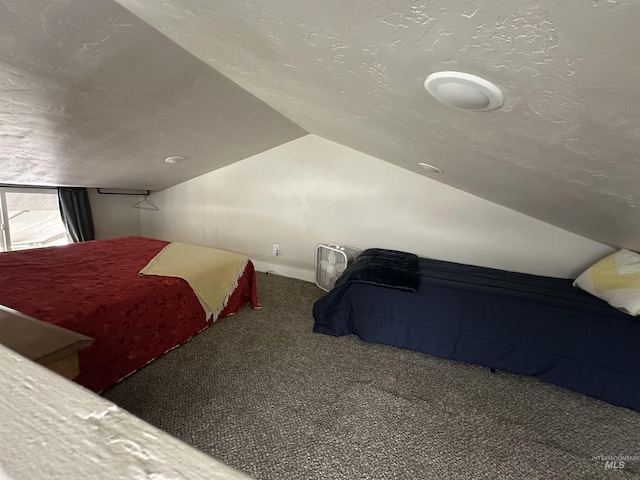 bedroom featuring carpet floors, a textured ceiling, and lofted ceiling