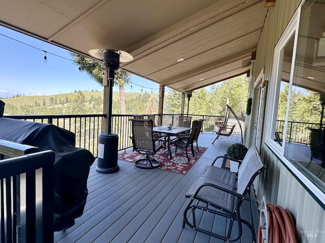 wooden terrace with outdoor dining area