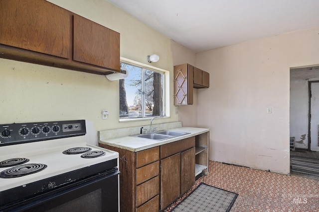 kitchen with white electric range oven and sink