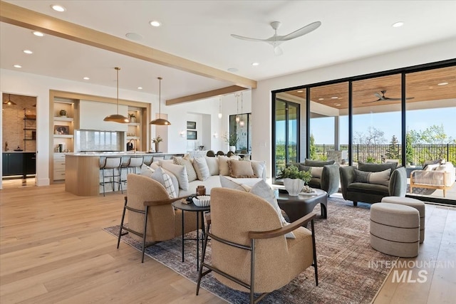 living room with recessed lighting, a wealth of natural light, a ceiling fan, and light wood-style flooring