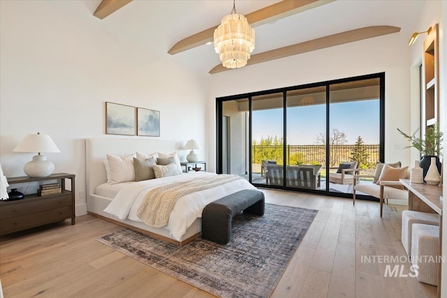 bedroom featuring hardwood / wood-style floors, a notable chandelier, and access to exterior