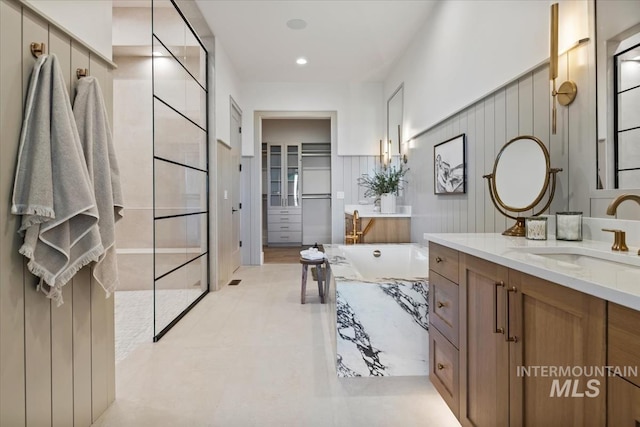 full bathroom with walk in shower, vanity, and a bathtub