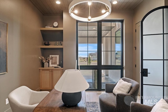 sitting room featuring wood finished floors, wooden ceiling, built in features, and recessed lighting