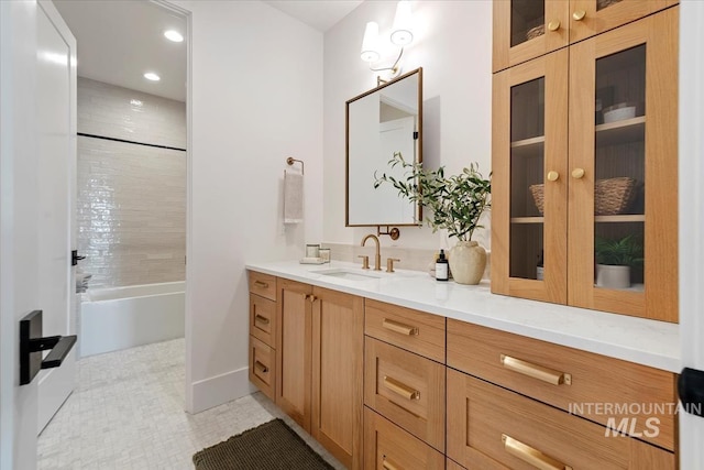 bathroom featuring recessed lighting, tub / shower combination, baseboards, and vanity