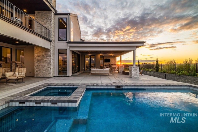 view of swimming pool featuring an outdoor living space, a patio area, fence, a fenced in pool, and an in ground hot tub