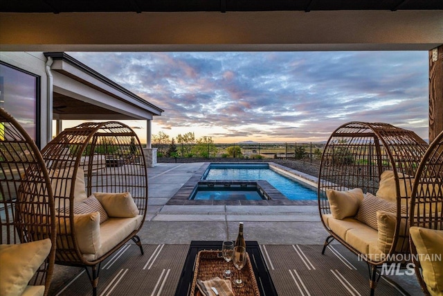view of pool with a patio, a fenced in pool, and an in ground hot tub