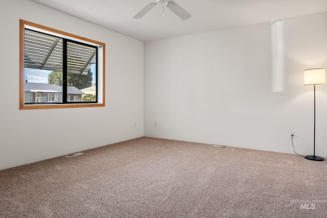 spare room featuring carpet and ceiling fan