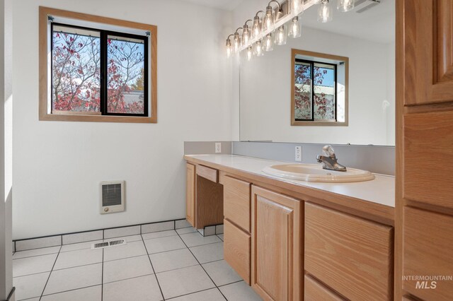 bathroom featuring vanity, tile patterned floors, and heating unit