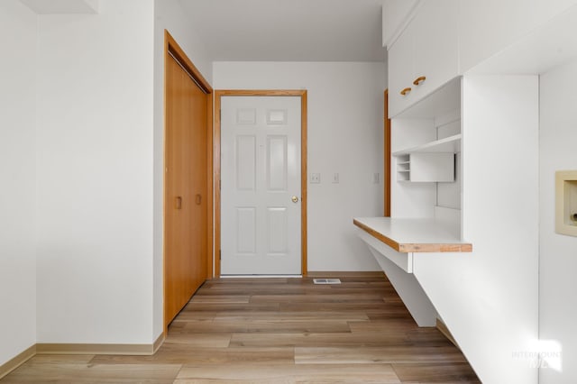 hallway with light wood-type flooring