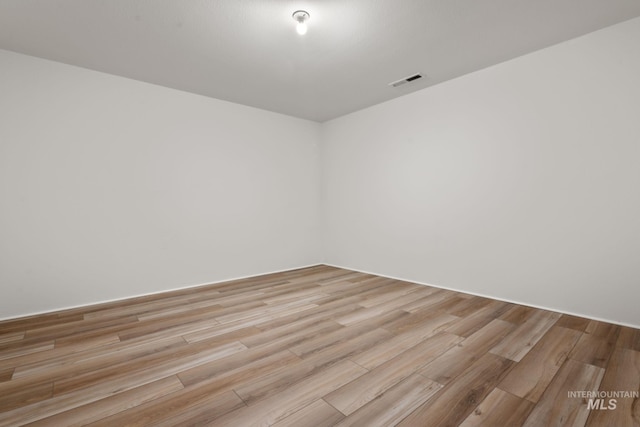 spare room with light hardwood / wood-style flooring