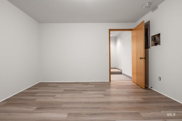 unfurnished room with light hardwood / wood-style flooring