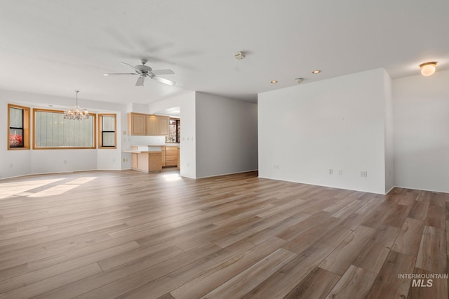 unfurnished living room with light hardwood / wood-style flooring and ceiling fan with notable chandelier